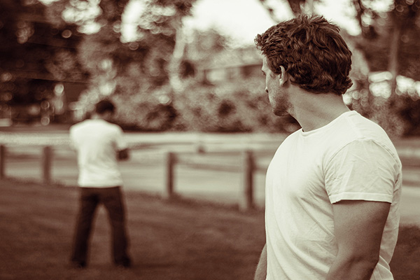 man looking at another man with his back turned